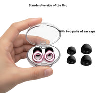 Pink earbuds in a clear case with two pairs of black ear caps on a white background.